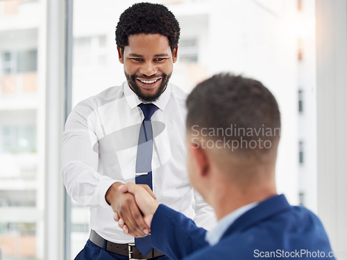 Image of Businessman, handshake and meeting in partnership for deal, agreement or introduction at the office. Black man employee shaking hands with colleague for b2b, teamwork or collaboration at workplace