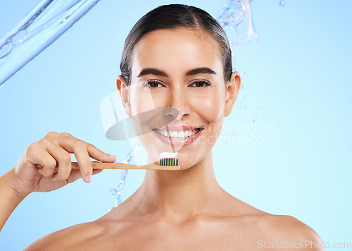 Image of Portrait, water or happy woman brushing teeth smiling with product for healthy oral or dental hygiene in studio. Face, smile beauty or girl model cleaning mouth with natural bamboo wooden toothbrush