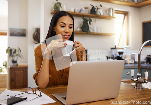 Image of Woman with coffee, remote work and laptop, reading or review with freelance employee drinking hot beverage and content. Working from home, female freelancer and technology with email and connectivity