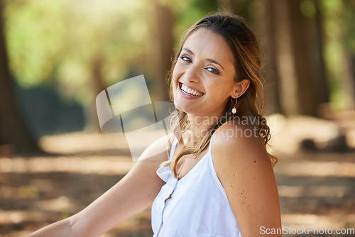 Image of Nature, happy and portrait of a woman in a forest on an outdoor adventure, explore or travel. Happiness, smile and face of a young female model posing in the woods with a positive mindset in summer.