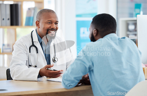 Image of Happy, talking and doctor with a black man for healthcare, support and advice on treatment. Smile, consulting and an African gp with a patient speaking about medicine, health and professional help