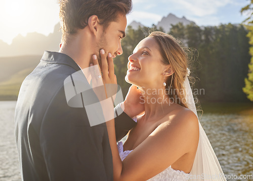 Image of Wedding, couple and lake water with a bride feeling love, care and support from marriage together. Nature, happiness and romance event of young people with a happy smile from trust and commitment