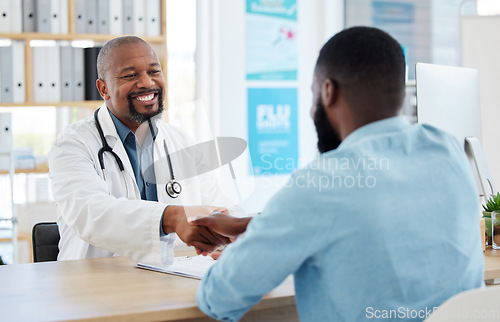 Image of Happy doctor, patient and handshake in healthcare for checkup, consultation or agreement at hospital. Black man, medical professional shaking hands with client for consulting, visit or appointment