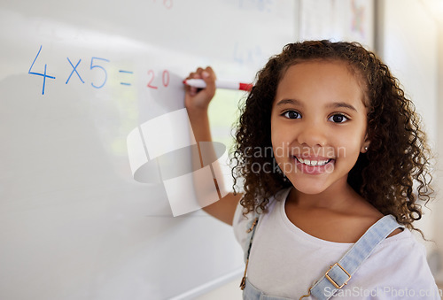 Image of Whiteboard, math and portrait of girl learning, studying and education in classroom. Development, mathematics and face of happy kid or student with equations, numbers and multiplication in school.