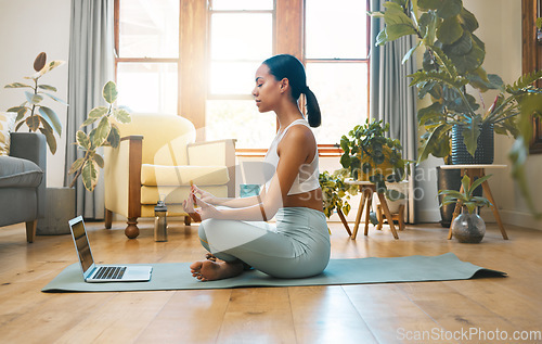 Image of Yoga, fitness meditation and woman on laptop for online class and workout with home, holistic health and wellness. Biracial person in lotus pose, meditate and training tutorial, streaming on computer