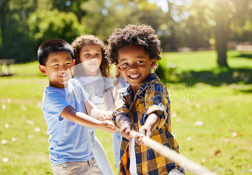 Image of Fun, games and kids playing tug of war together outdoor in a park or playground in summer. Friends, diversity and children pulling a rope while being playful fun or bonding in a garden on a sunny day