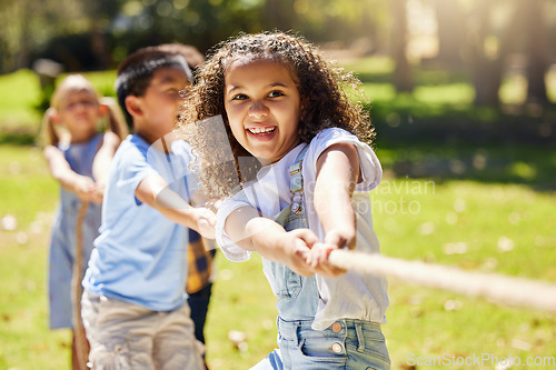 Image of Funny, games and children playing tug of war together outdoor in a park or playground during summer. Friends, diversity and kids pulling a rope while having fun or bonding in a garden on a sunny day