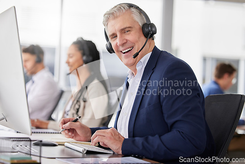 Image of Portrait, laughing and man in call center in office working on customer service in workplace. Telemarketing, mature person and funny sales agent, consultant and telemarketer writing information.