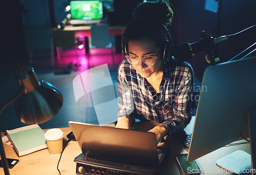 Image of Live streaming, computer and podcast woman typing news article, broadcast report or planning platform strategy at night. Journalist or person on laptop and microphone for student politics or radio