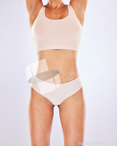 Image of Body, woman and stomach for healthy lifestyle in studio as motivation for weight loss, diet or sports fitness. Female underwear model on a white background for abdomen, gut health or tummy wellness