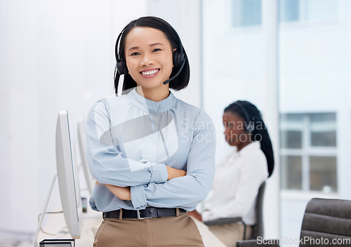 Image of Asian woman, call center and arms crossed in portrait, communication and CRM, headset with mic in office. Contact us, customer service or telemarketing, female consultant with smile and help desk