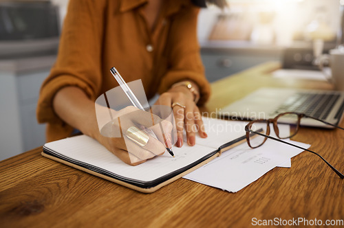 Image of Closeup, writing and woman on laptop with documents for budget, savings and paying bills in her home. Paper, financial and future planning, investment and growth by female checking finance notes