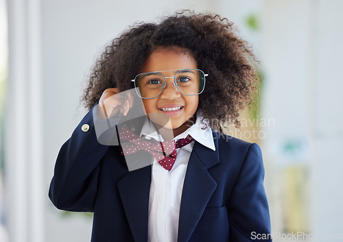 Image of Happy, portrait and a child dressed as an employee, playing in the office and having fun with work clothes. Smile, playful and a little girl wearing a suit to play pretend as a business person