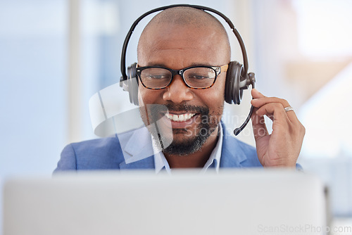 Image of Black man, call center and business consulting in customer support, telemarketing or service at office. Happy African American male consultant agent smiling with headphones and mic for online advice