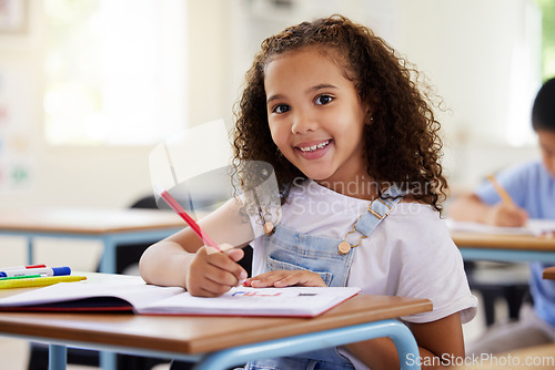Image of Learning, drawing and portrait of girl in classroom exam, education or studying with book. Preschool smile, development and happy kid or student coloring for creative art in notebook in kindergarten.
