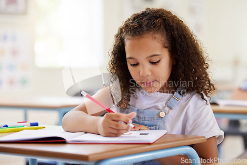 Image of Learning, drawing and girl in classroom for education, exam or studying with book. Preschool, creativity development and serious kid or student coloring for art in notebook in kindergarten or academy