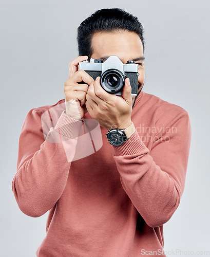 Image of Man with camera, photography and artist, taking picture with art isolated on white background. Photographer, focus with lens and creativity with vintage technology and creative male in studio