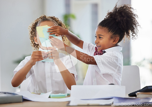 Image of Children, sticky note and face for play at office desk with happiness, brainstorming or teamwork at company. Kids, group girl and paper for planning, comic or playing as business people for bonding