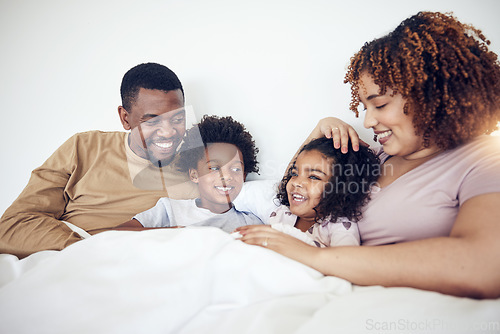 Image of Family, father and mother with children on bed relaxing together for fun morning or holiday break at home. Happy dad, mom and kids relax and lying in bedroom enjoying comfort and bonding time