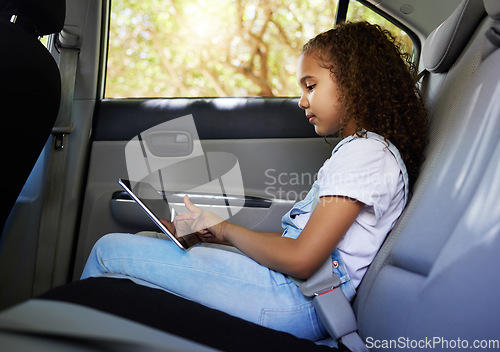 Image of Child in car, tablet and road trip with seatbelt for safety and device to watch educational video or online game. Technology, internet and summer travel, happy girl on backseat for drive or carpool.