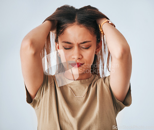 Image of Headache, annoyed and anxiety of woman in studio with pressure and frustrated. Mental health issue, young female and migraine of worker with a head massage and stress problem with background