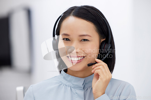 Image of Asian woman, call center and smile in portrait, communication and CRM, headset with mic in office. Contact us, customer service or telemarketing agent with happy female consultant and help desk