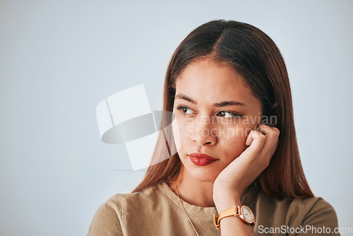 Image of Serious woman, thinking and space for idea in studio with advertising or product placement. Face of female on white background with doubt, planning or contemplating problem, plan or decision