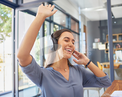 Image of Headphones, music and happy business woman dance in office, smile and excited while having fun. Podcast, radio and dancing female corporate employee relax with audio playlist, track or song at work