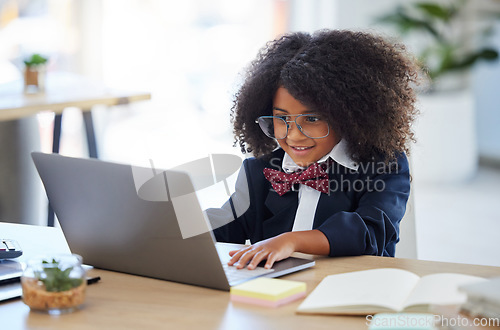 Image of Laptop, happy and a child pretending to be an employee, reading emails and playing on a computer. Smile, smart and a little girl typing on a pc to play pretend and acting as an office worker