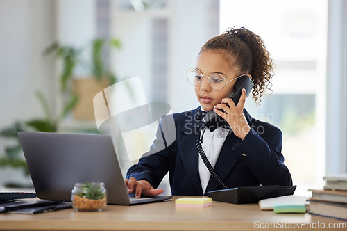 Image of Kids, telephone and a girl playing in an office as a fantasy businesswoman at work on a laptop. Children, phone call and a female child working at a desk while using her imagination to pretend