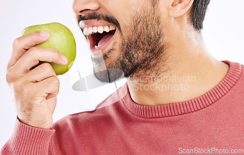 Image of Hand, apple and man in studio for diet, nutrition and weight loss with healthy breakfast on white background. Fruit, snack and male nutritionist eating organic, clean and fiber detox routine isolated