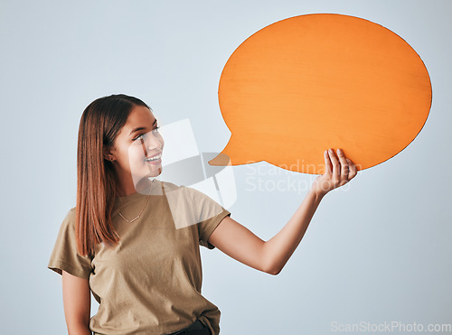Image of Speech bubble, smile and woman with mockup in studio isolated on a white background. Social media, poster and happy girl with billboard for voice, opinion or branding, marketing or advertising space.