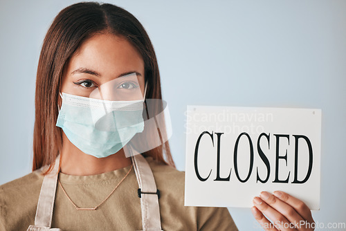 Image of Woman, closed sign and mask for covid in studio portrait for safety, wellness or board by background. Entrepreneurship, small business owner and paper poster for warning in management job by backdrop