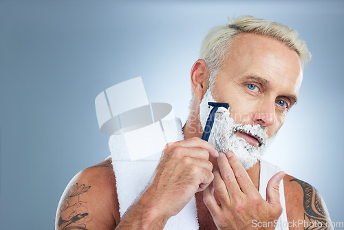 Image of Senior man, razor and shaving beard with cream for skincare grooming or hair removal against studio background. Portrait of mature male with shaver, creme or foam for clean facial treatment on mockup