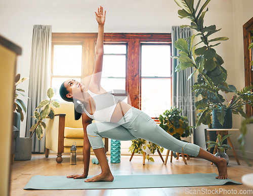 Image of Yoga, stretching and fitness woman in health training and workout at home or living room for wellness and balance. Young, biracial sports person in pilates or side plank for holistic body exercise