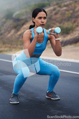 Image of Fitness, outdoor and woman doing a exercise with weights for strength, wellness and health. Sports, cardio and young female athlete doing a workout or training with equipment in nature in the road.