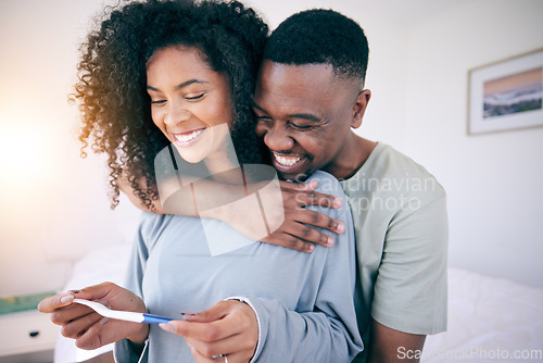 Image of Pregnancy test, hug and black couple in a home with a smile from baby news. Support, care and happy parents with a young and new mother and dad together feeling love with pregnant woman in bedroom