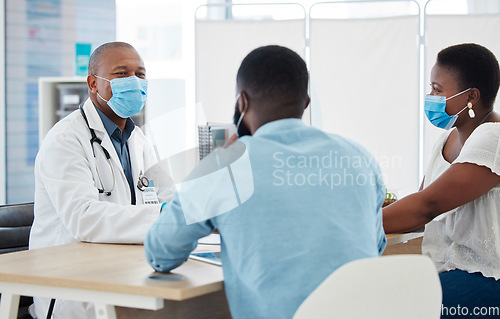 Image of Covid, healthcare and doctor consulting a black couple in a hospital for wellness, insurance or treatment. Medical, health or trust with a medicine professional talking to a man and woman in a clinic