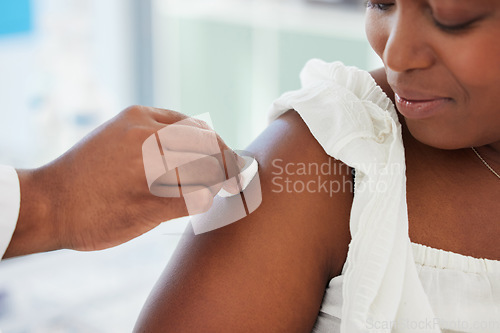 Image of Doctor cleaning the patient arm before an injection in a consultation room in the hospital. Healthcare, hygiene and hand of medical worker wipe the skin before a vaccine in a medicare clinic.