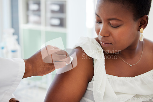 Image of Doctor wipe the patient arm before a vaccine in a consultation room in the hospital. Healthcare, hygiene and hand of medical worker cleaning the skin before an injection in a medicare clinic.