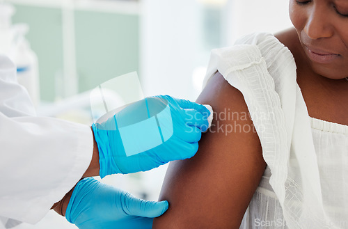 Image of Medical doctor cleaning an arm before an injection in a consultation room in the hospital. Professional, hygiene and hand of healthcare worker wipe the skin before a vaccine in a medicare clinic.