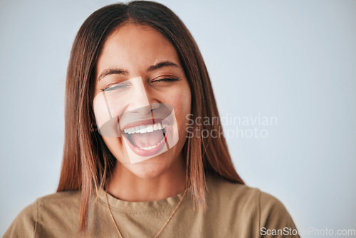 Image of Woman is laughing, happiness and face with freedom isolated on studio background, comedy and care free. Headshot, young female and joy with laughter, funny and mockup with humor and positive energy