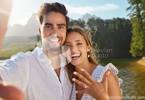 Image of Couple, portrait selfie and engagement by lake for celebration, happiness and excited for future. Man, woman and photography for social media, profile picture and romance for love, proposal and goals