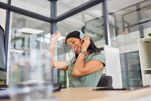 Image of Headphones, music and happy woman in office dancing for career happiness, mental health and job celebration. Black person, employee or business worker listening to audio tech for workplace wellness