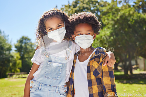 Image of Children hug, park and mask for covid in portrait with support, care or outdoor in summer sunshine. Kids, friends and embrace with girl, safety and solidarity at school, playground and backyard lawn