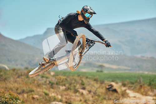 Image of Fitness, extreme sports and mountain bike with man in nature for cycling, jump and adventure. Adrenaline junkie, performance and stunt with athlete riding in outdoors for action, risk and training