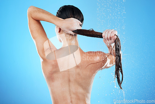 Image of Shower, woman rinsing hair from back and blue background in morning bathroom routine, hygiene and studio mockup. Healthy haircare, wellness and wet beauty model cleaning in water splash with mock up.