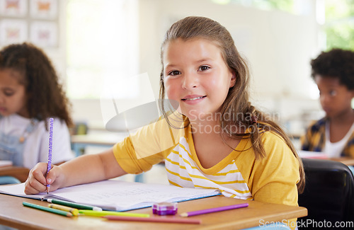 Image of Education, writing and portrait of girl in classroom learning, exam or studying with book. Preschool smile, development and happy kid or student write notes for knowledge in notebook in kindergarten.