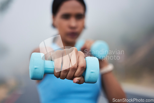 Image of Woman, hand with weightlifting and fitness, dumbbell and closeup with muscle training outdoor in street. Exercise, strong female and fist, healthy and active lifestyle with weights and wellness