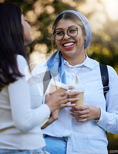 Image of Happy, break or students talking at park on university campus for learning, education or goals together. Girls talk, Islamic or students relaxing with coffee meeting for research or college knowledge